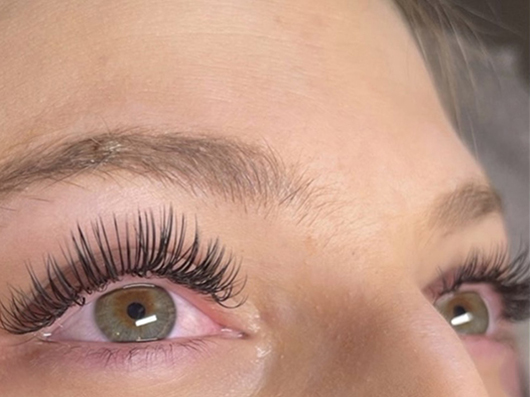 a close up view of a person's eyes focusing on their long lashes